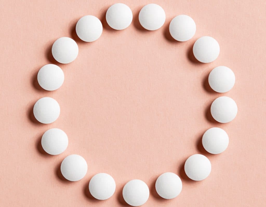 circle of dhea tablets on a counter top