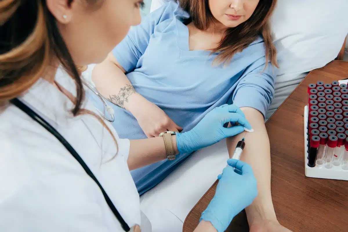 HRT Blog 50 image of a woman giving a blood sample to determine if she has autoimmune disease
